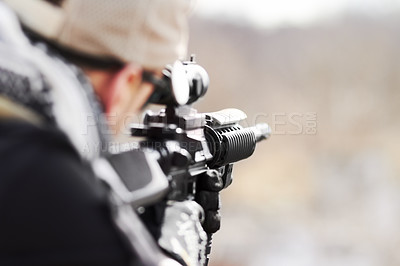 Buy stock photo Rearview of a snipper pointing his gun into the distance with copy space