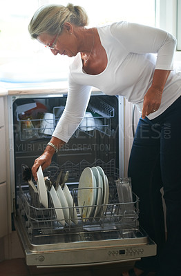 Buy stock photo Woman, dishwasher and plates in kitchen for clean crockery for meal eating, hygiene for happy home. Senior person, packing and machine for housekeeping working load for food or rack, scrub for dirty