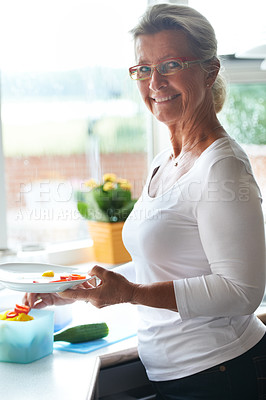 Buy stock photo Senior, woman and portrait dish vegetables for lunch meal for holiday food, retirement relax in home. Female person, face and smile for eating healthy vitamin or nutrition, kitchen counter at brunch