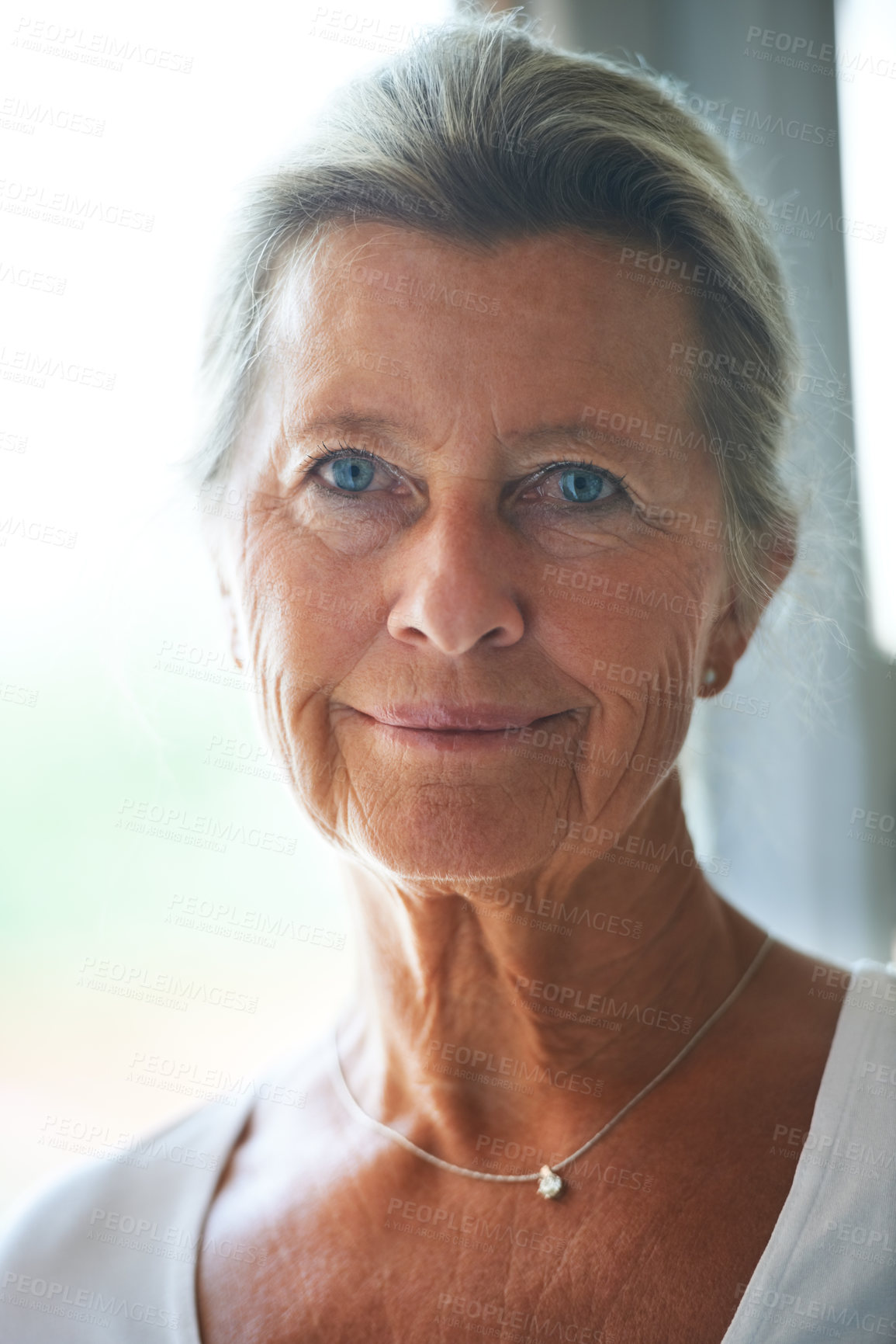 Buy stock photo A pretty senior woman smiling at you