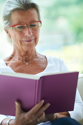 Buy stock photo Senior woman, book and reading in house, sofa and relax in living room with story, knowledge and glasses. Elderly lady, person and thinking on lounge couch in retirement with novel in nursing home