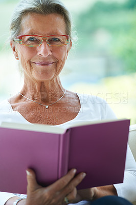 Buy stock photo Senior woman, sofa and book in portrait for reading, relax and living room with smile for story, knowledge or glasses. Happy elderly lady, person and face in lounge in retirement with novel in house