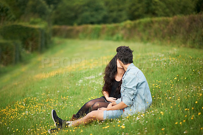 Buy stock photo Spring, field and couple kiss with love, romance and valentines celebration in nature, green meadow or outdoor. Young people or woman and partner relax in garden or park for countryside date together