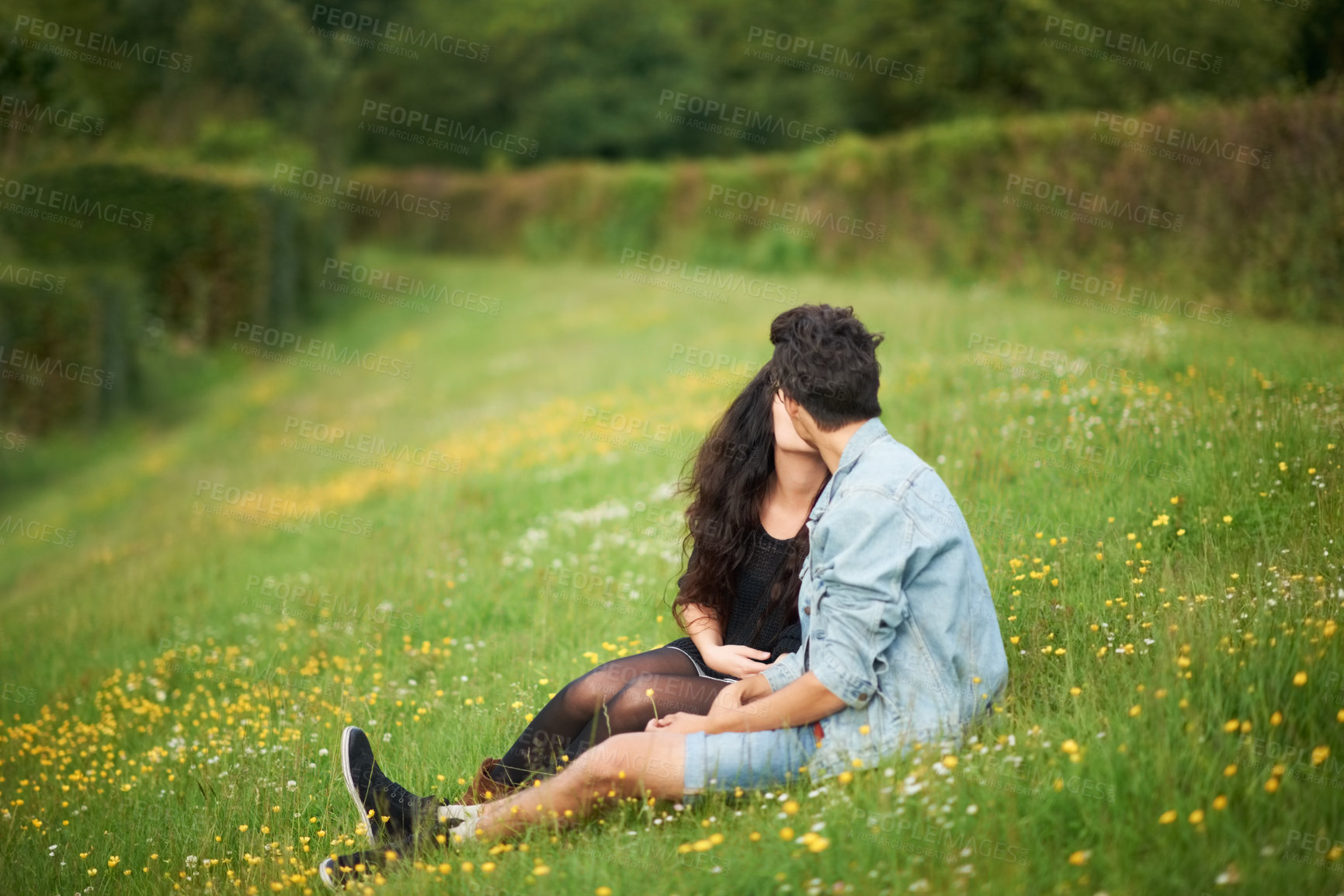 Buy stock photo Spring, field and couple kiss with love, romance and valentines celebration in nature, green meadow or outdoor. Young people or woman and partner relax in garden or park for countryside date together