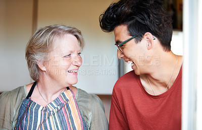 Buy stock photo Young guy sharing a joke with his mom at home
