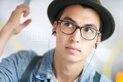 Buy stock photo Young guy taking public transport while listening to his mp3 player