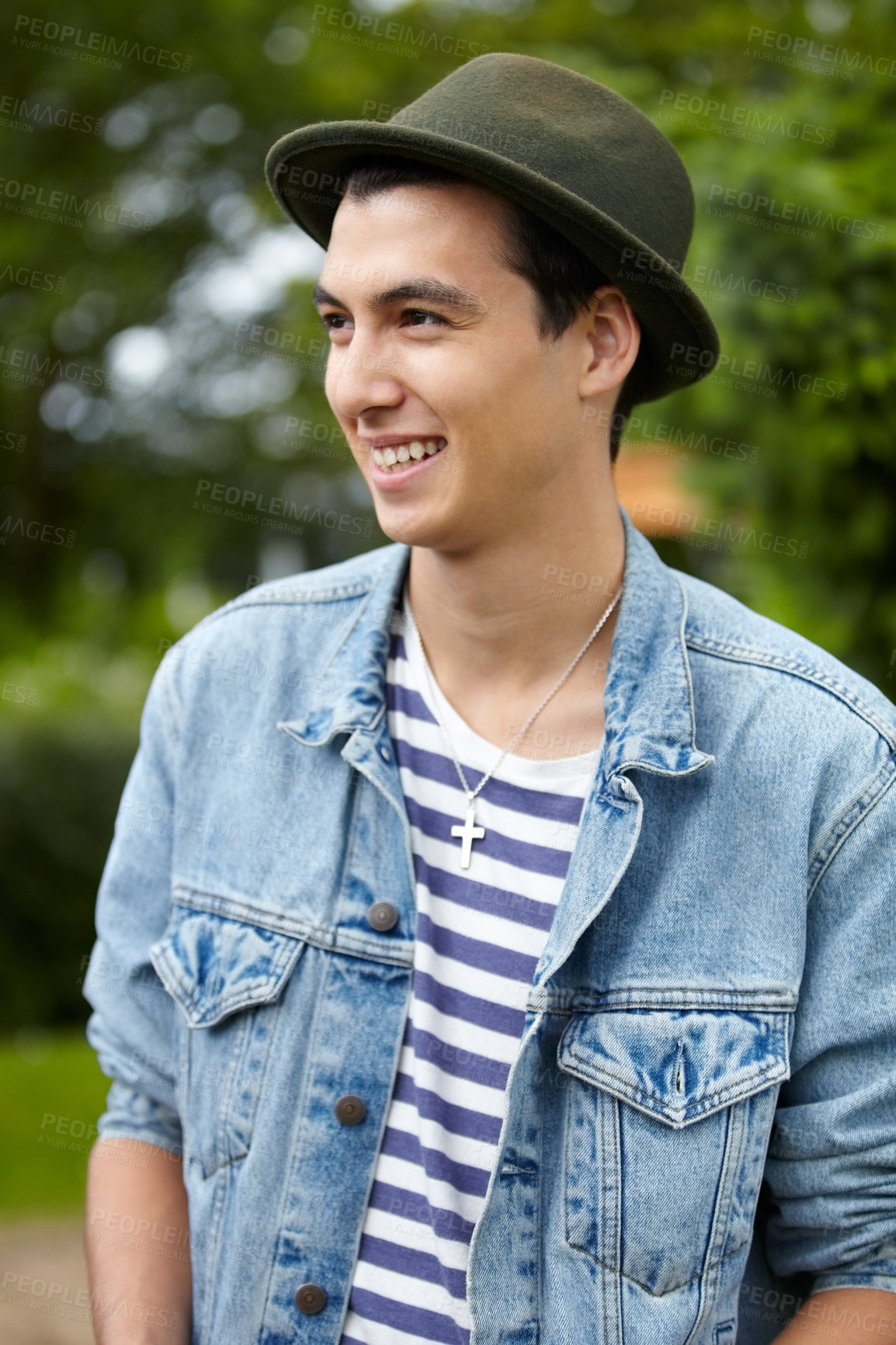 Buy stock photo Trendy young guy smiling while looking away outdoors