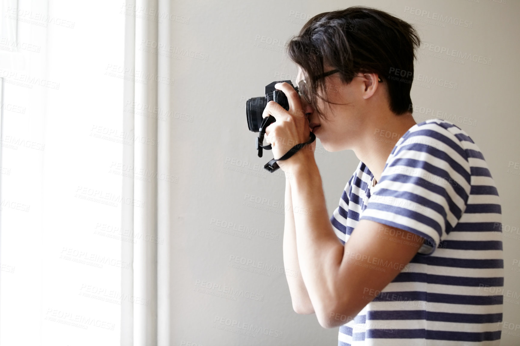 Buy stock photo Man, camera and photographer by window, creative and art in apartment, pictures and inspiration. Male person, confident and photography or lens, vintage technology and retro equipment or gadget