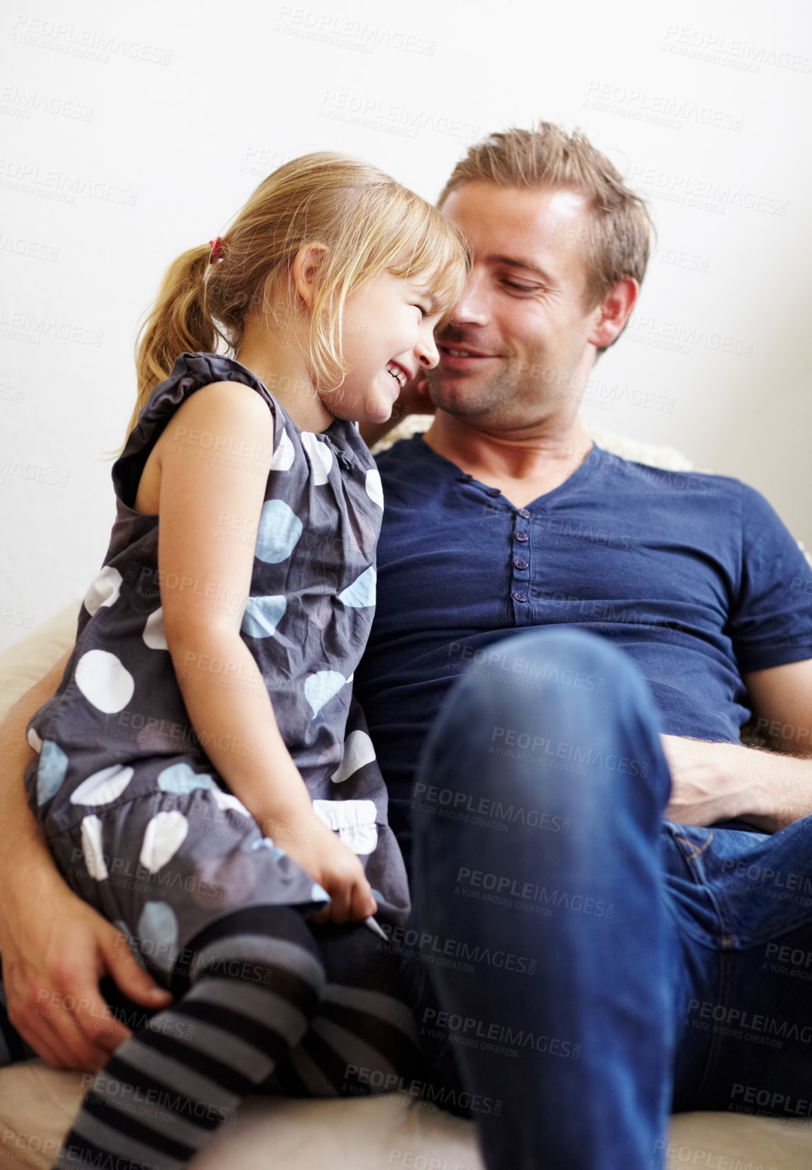 Buy stock photo Dad, girl and laugh with smile, couch and embrace with love, daughter and house. Man, happy and lounge for bonding together for relationship, affection and parent with child, caring and family home
