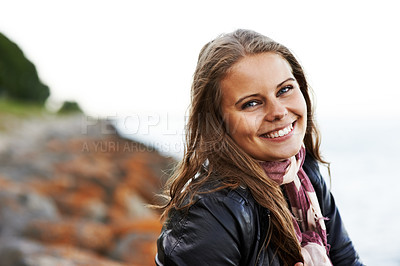 Buy stock photo Portrait, happy woman and smile on face for outside, trip or travel on holiday to coastline. Young person, excited emoji or expression with trendy, style and fashion on vacation, nature and Ireland