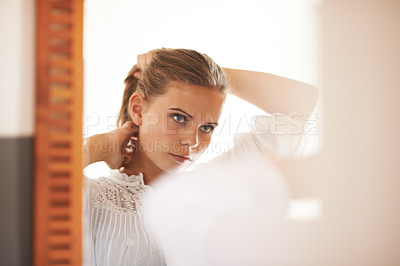 Buy stock photo Hair, care and teenager in morning with mirror and tying a ponytail hairstyle for school. College student, beauty and reflection of girl, face and style in home, apartment or preparation in bedroom