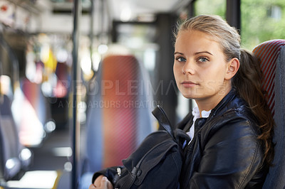 Buy stock photo A teenage girl sitting in the bus on the way home from school