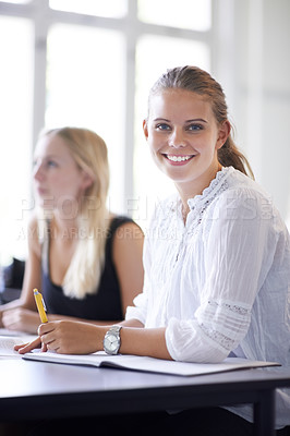 Buy stock photo A smiling teenage girl sitting in a classroom