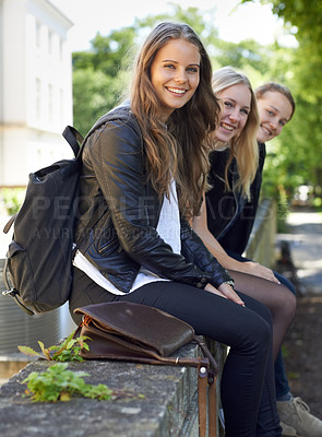 Buy stock photo School, friends and portrait of sitting on a wall, outdoor on campus with women and happiness. Social, students and smile for learning, education and studying at academy with backpack in morning