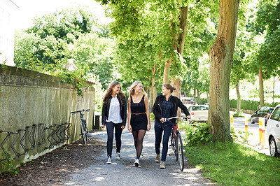 Buy stock photo Bicycle, friends and happy women walking at school together for education in university. Bike, students and group smile outdoor, teenager and girls at park travel, transportation and cycling on road