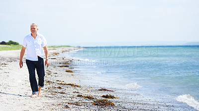 Buy stock photo Beach, walking and senior man on a travel tropical vacation, holiday or weekend trip in summer. Adventure, outdoor and elderly male person in retirement on the sand by the ocean or sea on getaway.