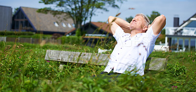 Buy stock photo A senior man relaxing on a park bench