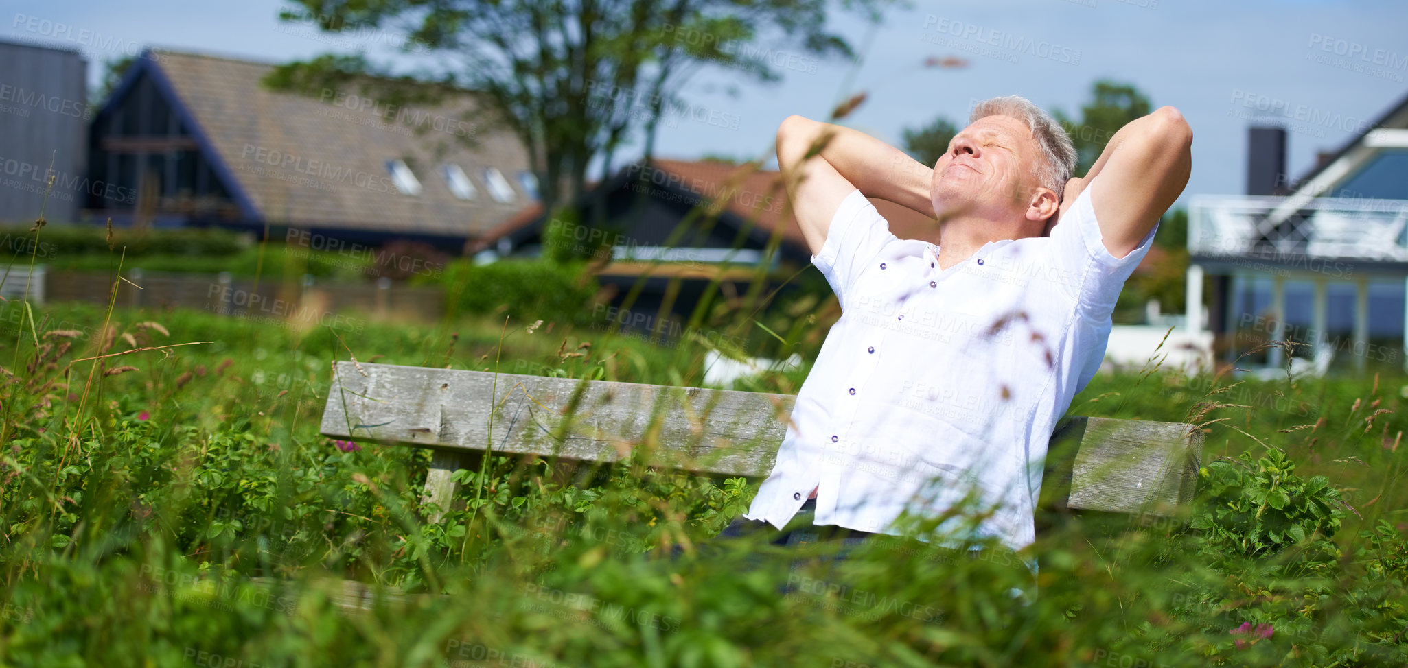 Buy stock photo A senior man relaxing on a park bench