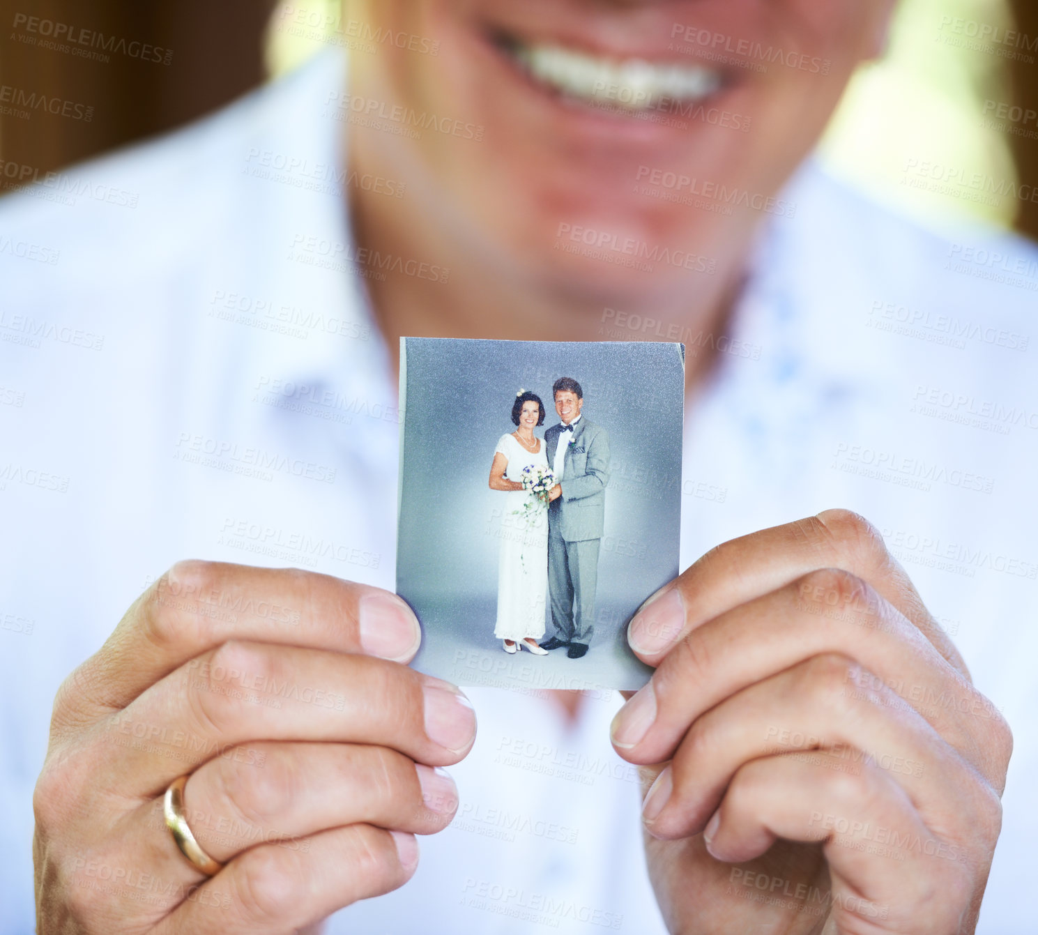 Buy stock photo Cropped hands of a person holding up an old wedding photo