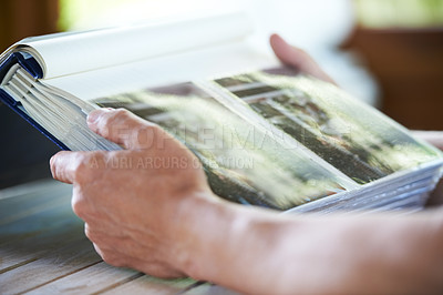 Buy stock photo Photo album, photographs and hands of person for memory, reflection and nostalgia in home. Family pictures, thinking and closeup of photos in book to remember past, childhood and memories of youth
