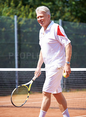 Buy stock photo Tennis, sports and senior man on court for playing game, match and practice for competition. Retirement, happy and elderly person with racket and ball for training, exercise and workout for hobby