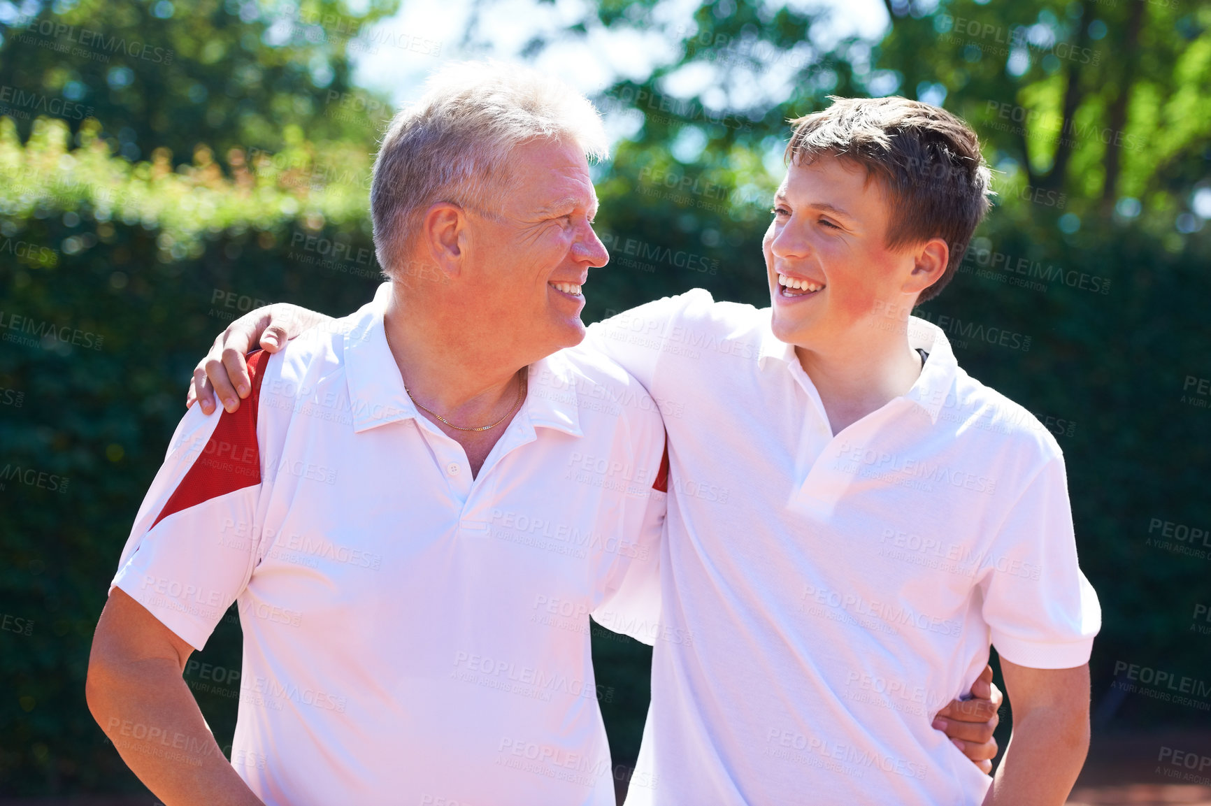 Buy stock photo A father and his son out in the sunshine while wearing tennis clothes