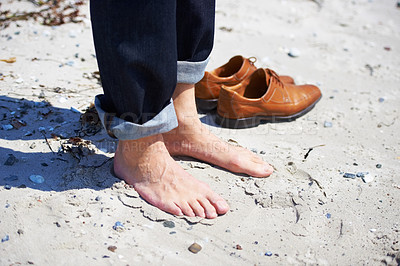 Buy stock photo Cropped closeup of a person bare feet in the sand