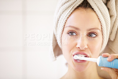 Buy stock photo Cropped shot of an attractive young woman brushing her teeth