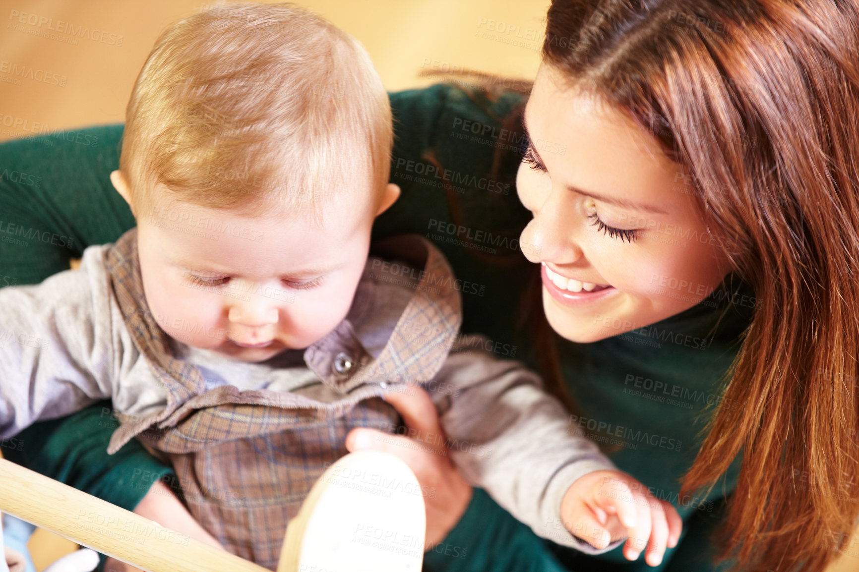 Buy stock photo Mother, holding and baby with smile for child development with toys for future, growth or milestone in home. Woman, infant or family in living room for bond in relationship with love, care or support