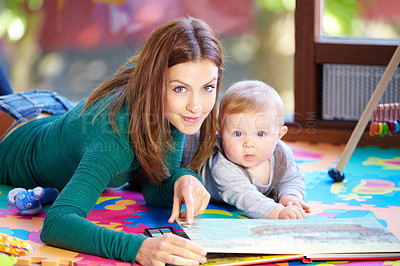 Buy stock photo Portrait, woman and baby with book in home for learning, development or cognitive growth for education. Mother, son or family with reading, bond and lying on floor in living room with toys for future