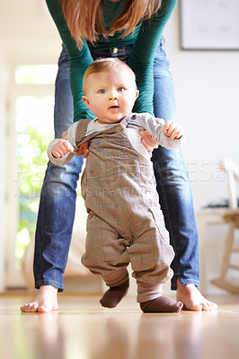 Buy stock photo Mother, baby and face with help for walking in home for motor skills, development or milestone with assistance. Son, toddler and excited for mobility, movement or freedom in living room with support