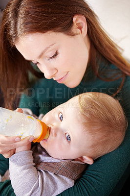 Buy stock photo Face, woman and holding of baby with bottle for feeding in home for health, diet and nutrition with formula for hunger. Mother, watch and son for growth, development or milestone for future with care
