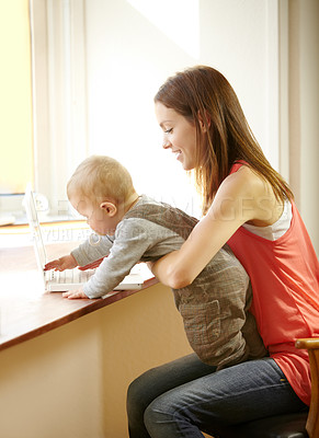 Buy stock photo Mother, holding and baby with laptop in home for remote, work or bond with child in kitchen. Young woman, parenting and son by smile for growth, milestone or development for care, love and support