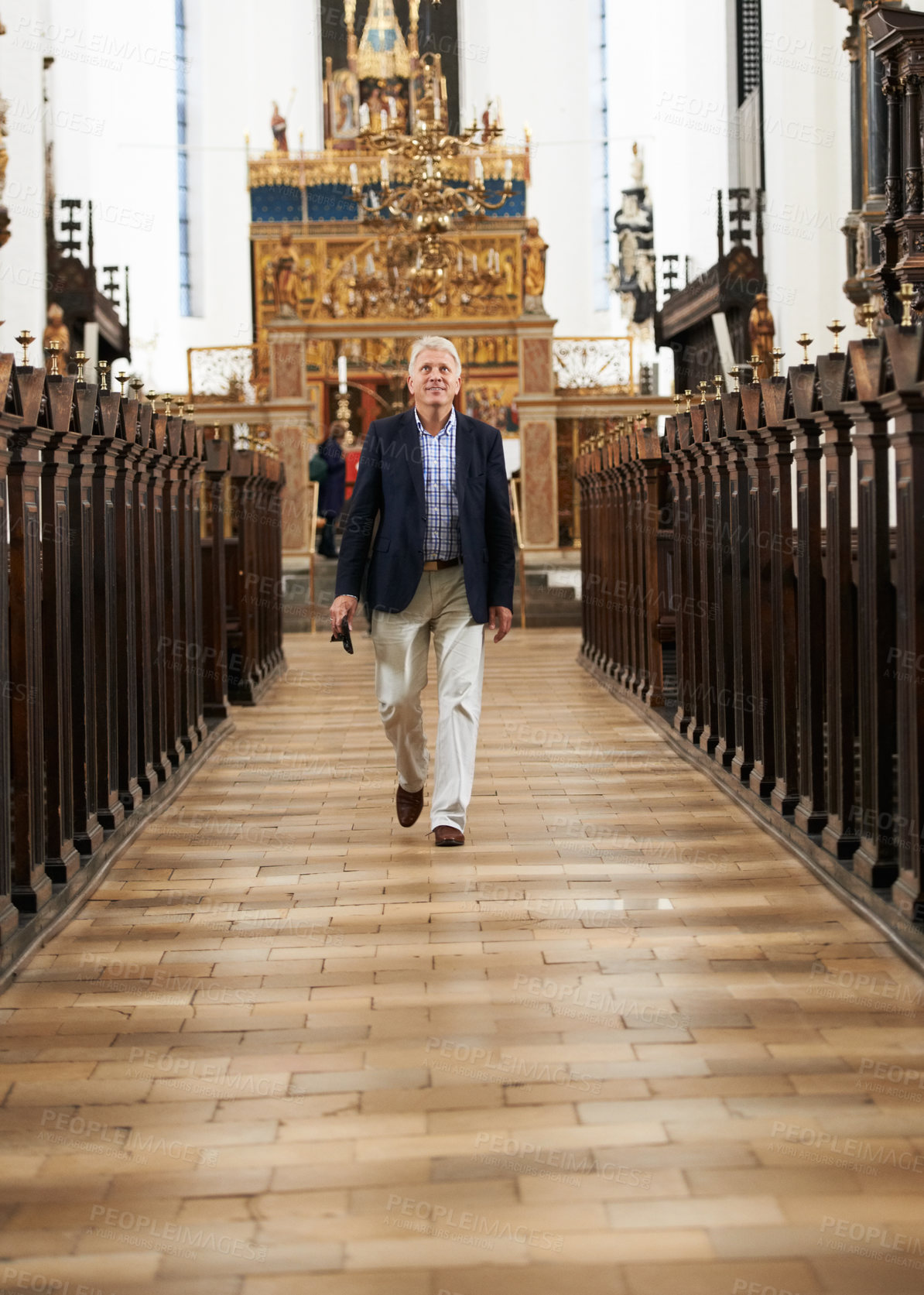Buy stock photo Walking, aisle and senior man in a church for sightseeing on a weekend trip, vacation or holiday. Portrait, religion and holy elderly male person in retirement in a worship cathedral in the city.