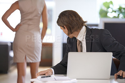 Buy stock photo Young man checking out a coworker's behind at work
