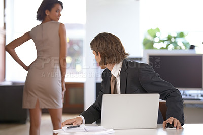 Buy stock photo Ethics, sexual harassment and a business man in the office with a woman colleague. Fantasy, company or affair with a male employee looking at the back of a female coworker in the corporate workplace