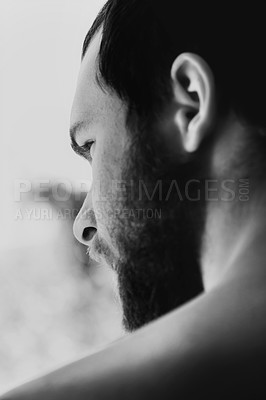 Buy stock photo Rear view closeup of a bearded young man looking away thoughtfully