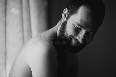 Buy stock photo Creativity, man and smile in a bedroom at home with monochrome and black and white. Shy male person, calm thinking and art in the morning in a house with happy memory and relax with solitude