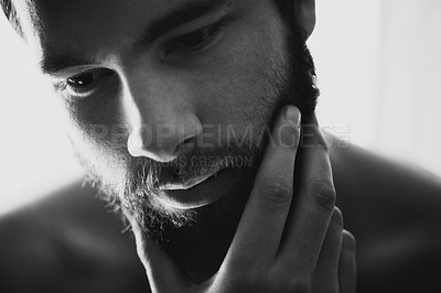 Buy stock photo Closeup of a handsome man rubbing his chin thoughtfully