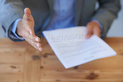 Buy stock photo Cropped closeup of a businessman holding your resume and offering you a handshake
