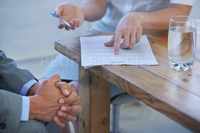 Buy stock photo Cropped image of two businesspeople discussing a resume