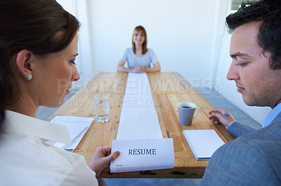 Buy stock photo Two employers astounded by the long resume a candidate has brought in to an interview