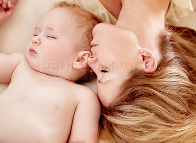 Buy stock photo Tiny baby boy lying fast asleep alongside his mother