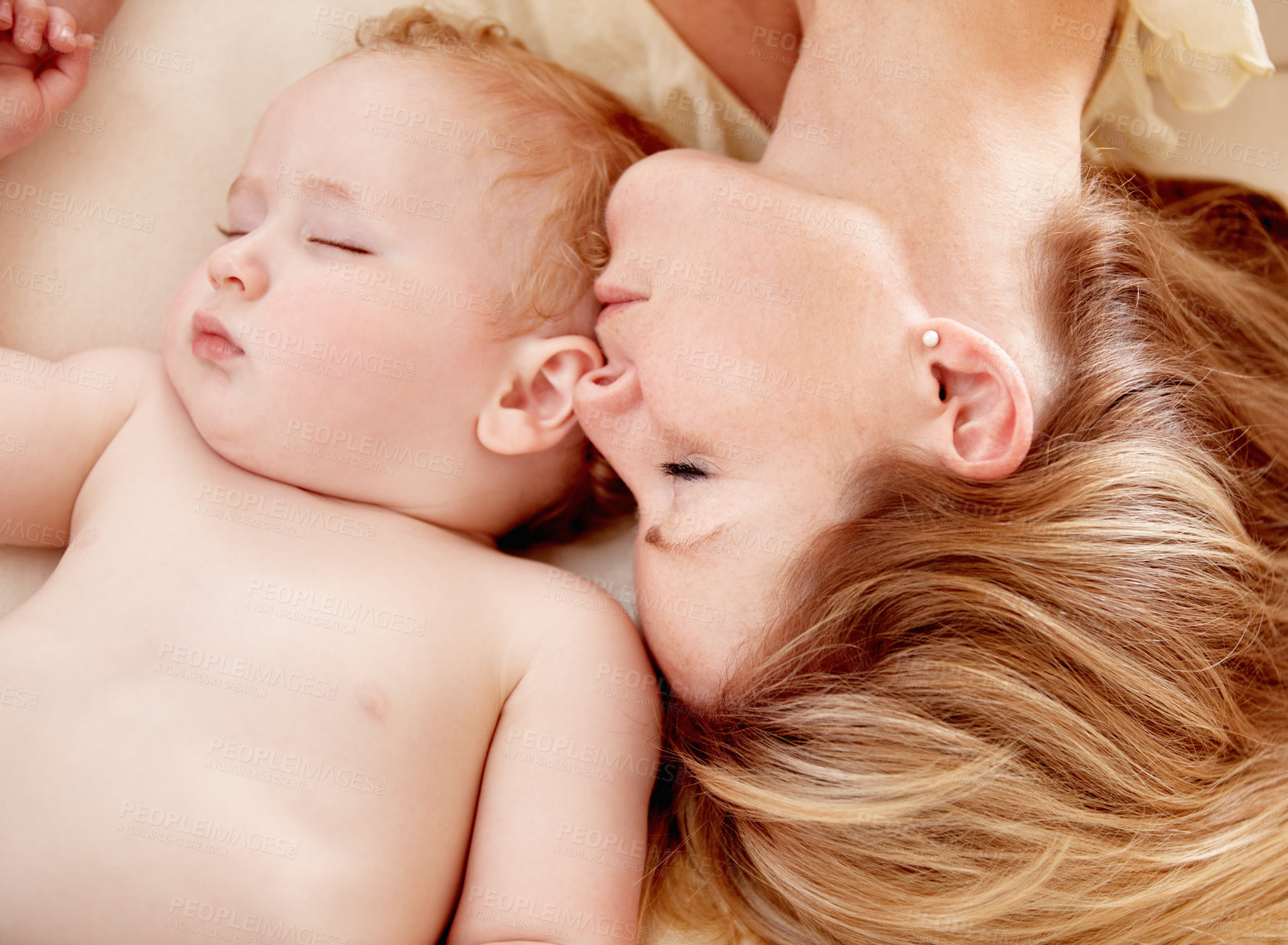 Buy stock photo Tiny baby boy lying fast asleep alongside his mother