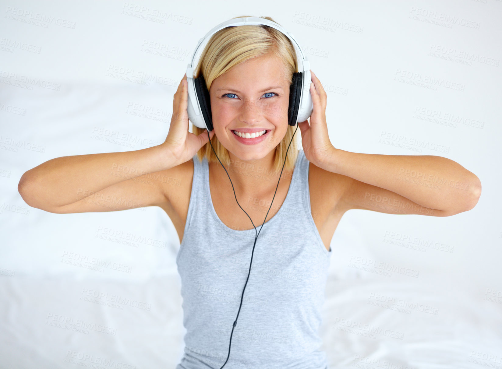 Buy stock photo Portrait, home and woman with headphones, streaming music and listening to audio with radio, apartment and sound. Face, smile or person with a headset, podcast and wellness with peace, bed or hearing