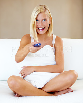 Buy stock photo Relax, portrait and happy woman on sofa watching tv with remote, pillow and streaming movies in home. Smile, television and girl on couch in living room with choice of fun video, film or network show