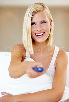 Buy stock photo Relax, portrait and happy woman on couch watching tv with remote, pillow and streaming movies in home. Smile, television and girl on sofa in living room with choice of fun video, film or network show