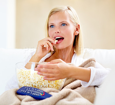 Buy stock photo A beautiful young woman watching a movie at home