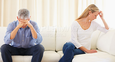Buy stock photo Mature married couple sitting on the sofa and having a disagreement