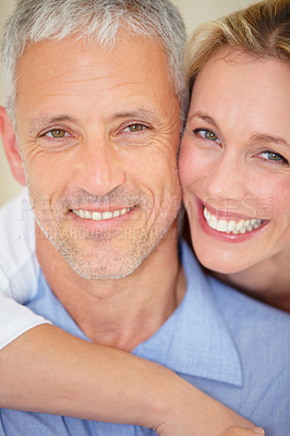 Buy stock photo Happy couple, face and portrait hug for love, support or care in romance together on holiday weekend at home. Closeup of mature woman, man smile or hugging in embrace, bonding or honeymoon at house